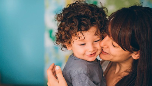 madre dando beso a su hijo
